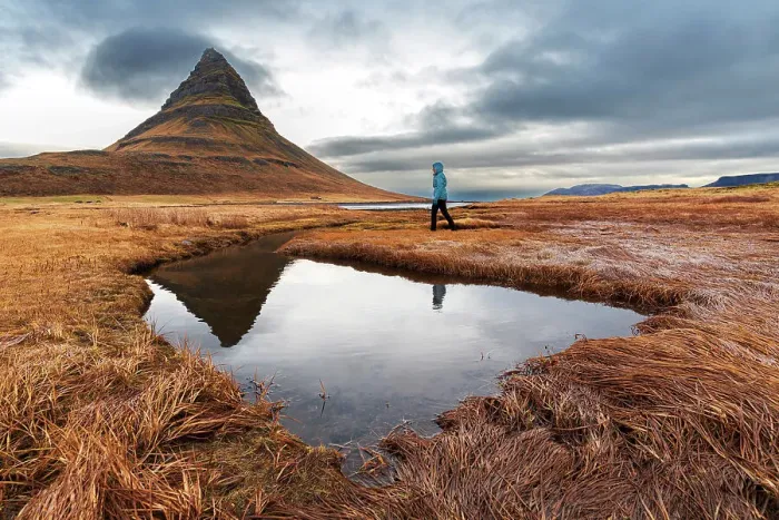 Framed Print : Woman walks in front of the famous Kirkjufell mountain reflecting in the water of a small lake, Snaefellsnes Peninsula, Western Iceland, Iceland, Polar Regions Framed Print : Woman walks in front of the famous Kirkjufell mountain reflecting in the water of a small lake, Snaefellsnes Peninsula, Western Iceland, Iceland, Polar Regions