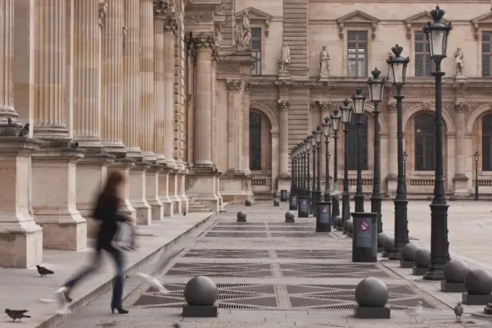 Framed Print : A woman walks through the Louvre Museum in Paris, France, Europe Framed Print : A woman walks through the Louvre Museum in Paris, France, Europe