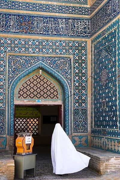 Woman in white chador enters Jameh Mosque, Varzaneh, Iran, Middle East