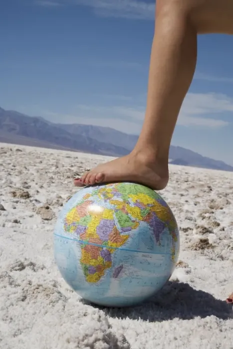Framed Print : Womans foot on globe Framed Print : Womans foot on globe