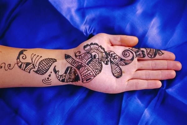 Womans hand decorated with henna design