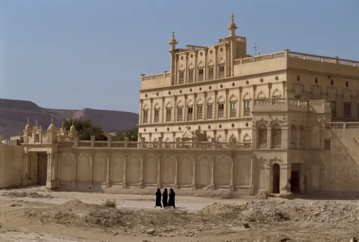 Framed Print : Women in black passing the house of a trader made rich