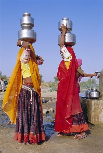 Two women by a well carrying water pots