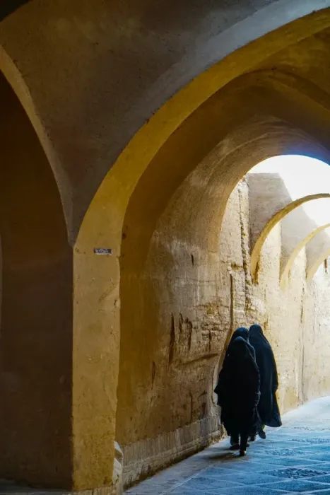 Framed Print : Three women in chadors hurrying down typical vaulted alleyway, Yazd, Iran, Middle East Framed Print : Three women in chadors hurrying down typical vaulted alleyway, Yazd, Iran, Middle East