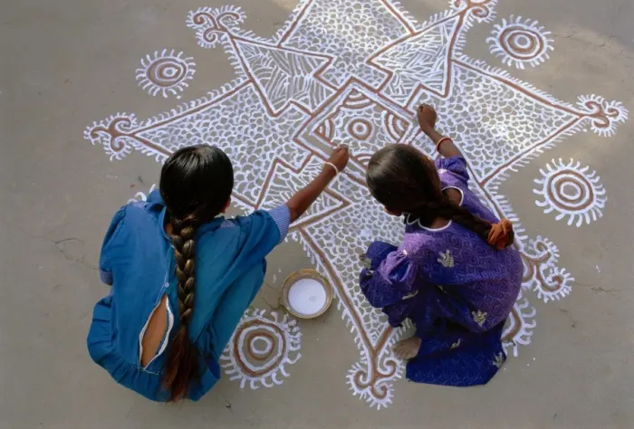 Framed Print : Women painting a Mandana on the ground Framed Print : Women painting a Mandana on the ground