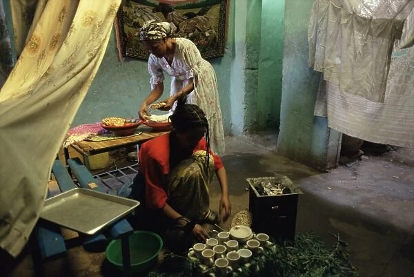 Women preparing food and drink for coffee ceremony, Abi Adi village, Tigre region