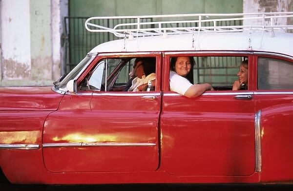 Women waiting in taxi in the early morning, Havana, Cuba, West Indies, Central America