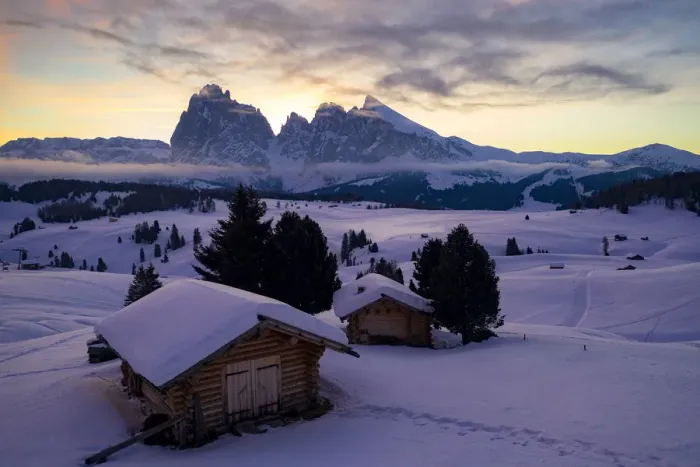 Framed Print : Wood cabins covered with snow with Sassopiatto and Sassolungo in background at dawn Framed Print : Wood cabins covered with snow with Sassopiatto and Sassolungo in background at dawn