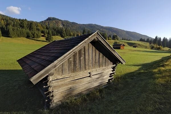 Wooden barns dot the alpine landscape
