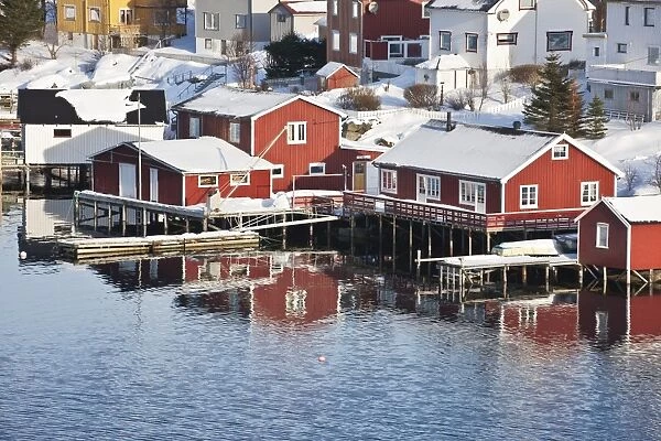 Wooden cabins at the waters edge in the town of Raine in the Lofoten Islands, Arctic, Norway, Scandinavia, Europe