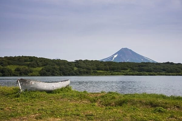 Wooden canoe in front of the Ilyinsky (volcano) and Kurile Lake, Kamchatka, Russia, Eurasia