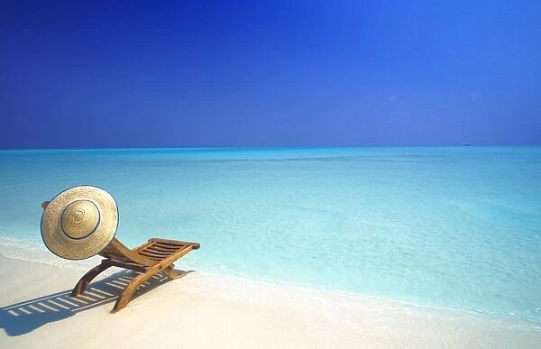 Wooden deckchair and hat on tropical beach, Maldives, Indian Ocean, Asia