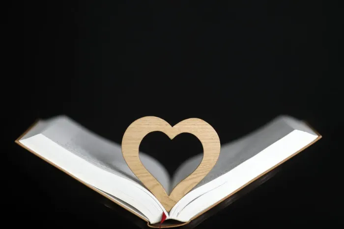 Framed Print : Wooden heart sculpture with a Bible, France, Europe Framed Print : Wooden heart sculpture with a Bible, France, Europe