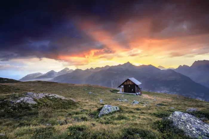 Framed Print : Wooden hut under fiery sky and clouds at sunset, Muottas Muragl, St. Moritz, Canton of Graubunden