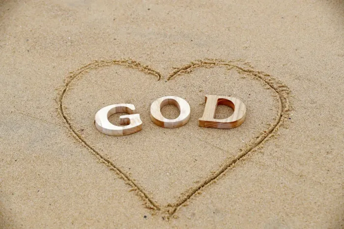 Framed Print : Wooden letters forming the word GOD with heart on a background of beach sand Framed Print : Wooden letters forming the word GOD with heart on a background of beach sand