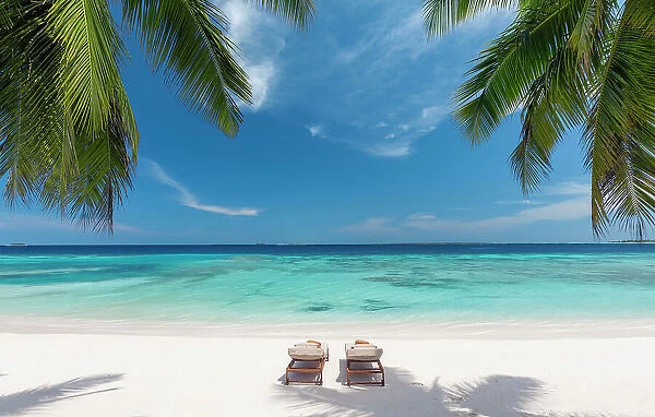 Wooden lounge chairs on a beautiful tropical beach, The Maldives, Indian Ocean, Asia