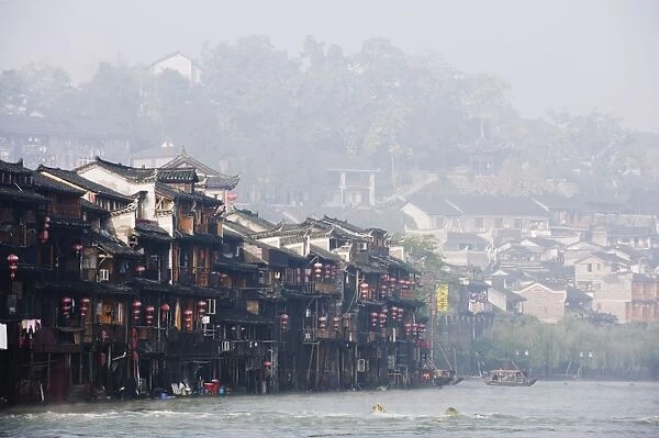 Wooden stilt houses in riverside old town of Fenghuang, Hunan Province, China, Asia