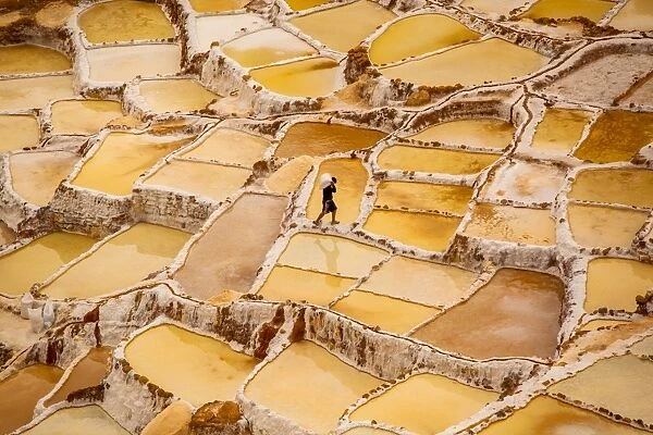 Worker mining for salt, Salineras de Maras, Maras Salt Flats, Sacred Valley, Peru