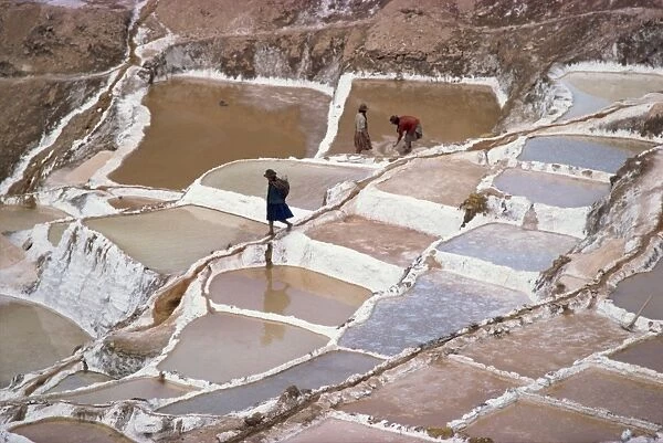 Workers in the salt pans on terraces at Salinas