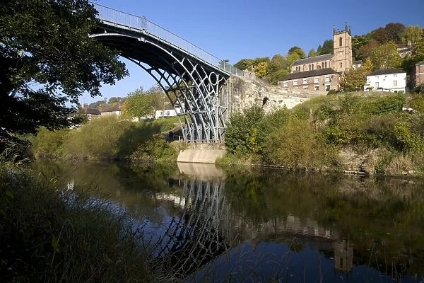 Worlds first iron bridge spans the banks of the River Severn in autumn sunshine, Ironbridge