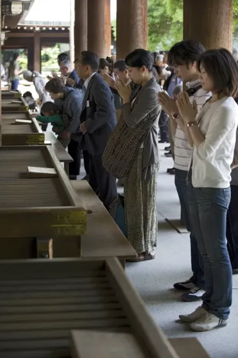 Framed Print : Worshippers praying in front of offertory boxes at main hall of Meiji Jingu shrine in Tokyo