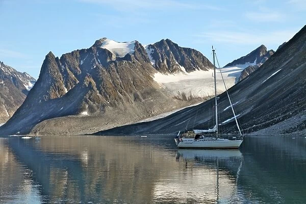 Yacht anchored under a glacier, Magdalenefjord, Svalbard, Norway, Scandinavia, Europe
