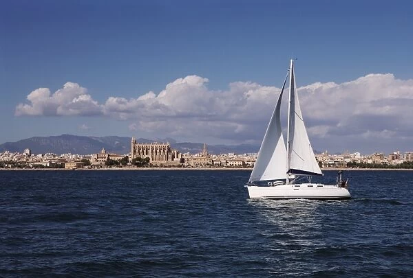 Yacht in the Bay of Palma looking back to La Seu Cathedral, Mallorca, Balearic Islands