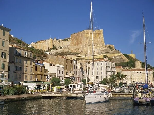 Yacht moored in harbour, with the citadel behind, Bonifacio, Corsica, France