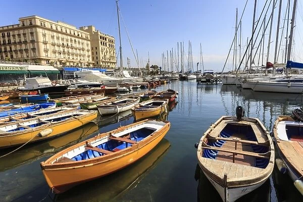 Yachts and colourful rowing boats in the marina Borgo Marinaro, Vesuvius in distance