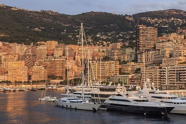 Yachts in the glamorous Port of Monaco (Port Hercules) at sunrise, from the sea, Monte Carlo