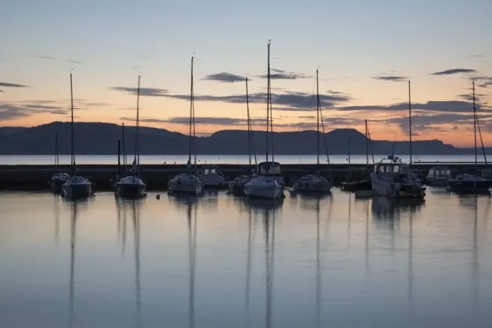 Framed Print : Yachts moored in The Cobb with Jurassic Coast and Golden Cap at sunrise, Lyme Regis Framed Print : Yachts moored in The Cobb with Jurassic Coast and Golden Cap at sunrise, Lyme Regis