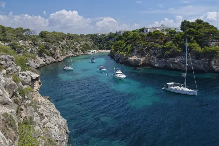 Framed Print : Yachts moored in the cove at Cala Pi, viewed from narrow cliff top coast path Framed Print : Yachts moored in the cove at Cala Pi, viewed from narrow cliff top coast path