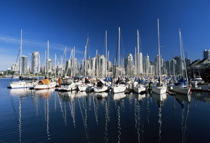 Framed Print : Yachts moored in False Creek marina, with downtown skyscrapers behind, Vancouver