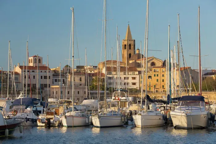 Framed Print : Yachts moored in marina beneath the Old Town walls, sunrise, bell tower of the cathedral prominent on skyline, Alghero, Sassari, Sardinia, Italy, Mediterranean, Europe