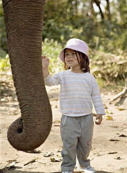 Two year old girl and the elephant that will take her on safari