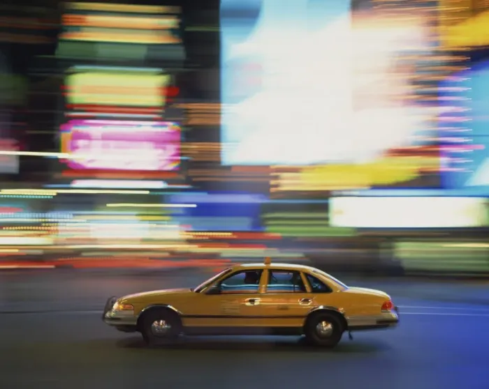 Framed Print : Yellow cab driving past blurred neon lights at night in Times Square in New York Framed Print : Yellow cab driving past blurred neon lights at night in Times Square in New York