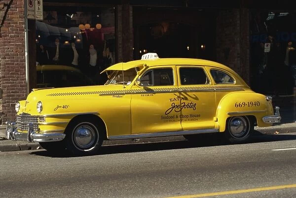Yellow cab on a street in Vancouver, British Columbia, Canada, North America
