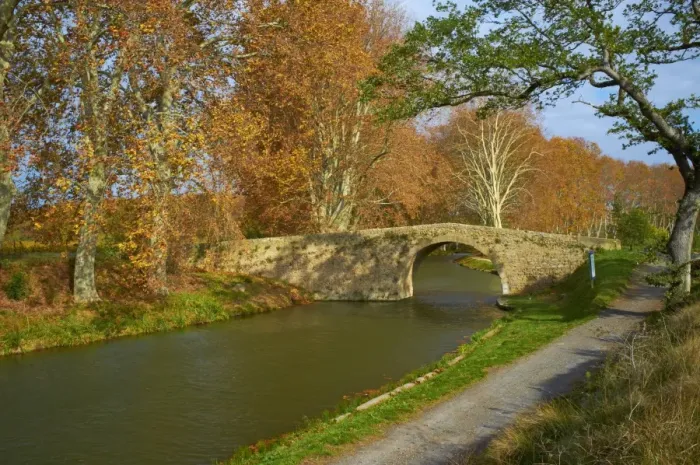 Framed Print : Yellow and red leaves in autumn and old bridge along the Canal du Midi Framed Print : Yellow and red leaves in autumn and old bridge along the Canal du Midi