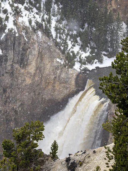 Yellowstone waterfall during a snowstorm in Yellowstone National Park