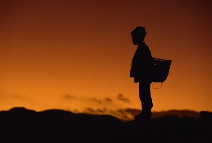 Framed Print : Young boy silhouetted against sky at dusk, Tibet, China, Asia Framed Print : Young boy silhouetted against sky at dusk, Tibet, China, Asia