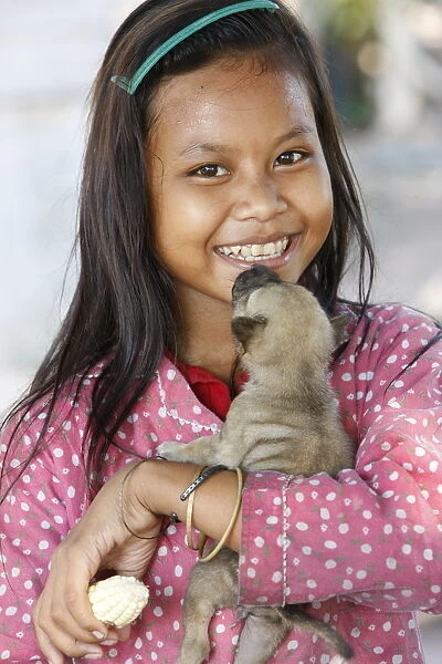 Young Cambodian girl and her little dog, Siem Reap, Cambodia, Indochina, Southeast Asia