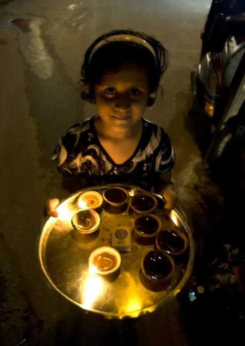Framed Print : Young girl carrying deepak lights on tray at Diwali, Udaipur, Rajasthan, India, Asia Framed Print : Young girl carrying deepak lights on tray at Diwali, Udaipur, Rajasthan, India, Asia