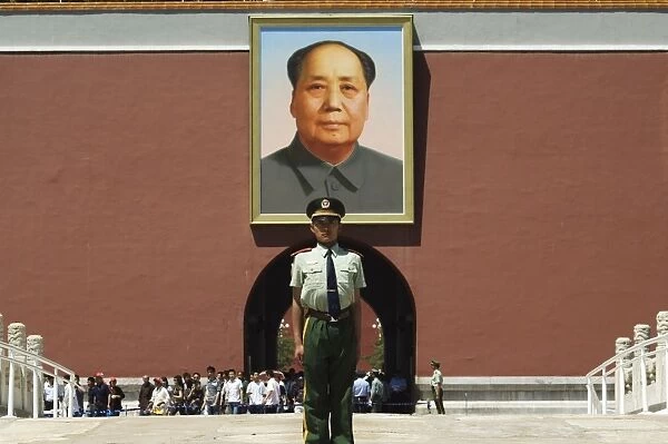 Young guard in front of a portrait of Mao Zhe Dong on the Gate of Heavenly Peace built in the 15th century on the edge of Tiananmen Square, Beijing
