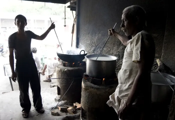 Framed Print : Young man and blind man stirring milk for chai, roadside chai stall, Dangiyawas