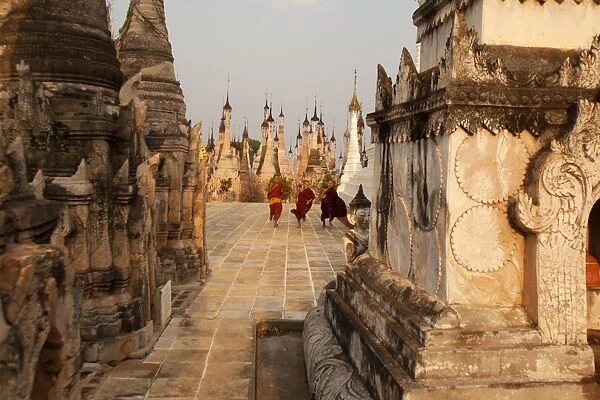 Young novices run through the pagodas, Kakku Pagoda Complex, Myanmar (Burma), Asia