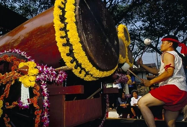 Young Thai man playing drums in parade