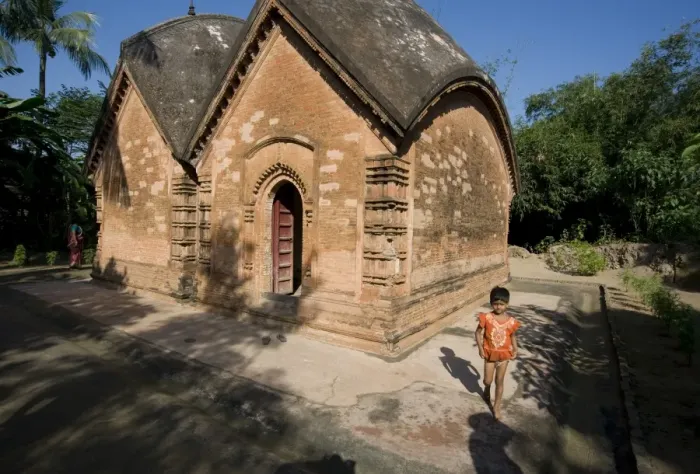 Framed Print : Young village girl beside restored miniature terracotta Hindu temple to Shiva Framed Print : Young village girl beside restored miniature terracotta Hindu temple to Shiva