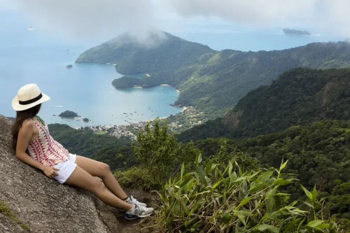Framed Print : Young woman looking out over the Green Coast (Costa Verde) from Papapagaio peak Framed Print : Young woman looking out over the Green Coast (Costa Verde) from Papapagaio peak