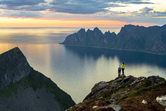 Framed Print : Two young women watching sunset standing on mountain top, Senja island, Troms county Framed Print : Two young women watching sunset standing on mountain top, Senja island, Troms county