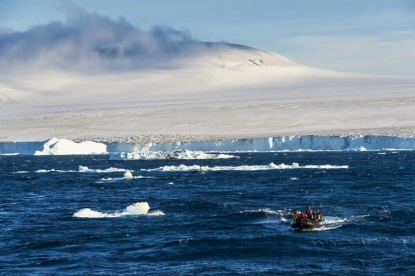 Zodiac with tourists cruising through the icebergs, Brown Bluff, Tabarin Peninsula